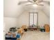 Spacious bonus room with vaulted ceiling, carpet, and natural light at 8000 Abington Dr, Locust Grove, GA 30248