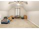 Spacious bonus room with vaulted ceiling, ceiling fan and neutral carpet at 8000 Abington Dr, Locust Grove, GA 30248