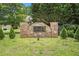 Stone sign reads The Arbors at Eagle's Brooke surrounded by landscaping at 8000 Abington Dr, Locust Grove, GA 30248