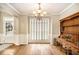 Elegant dining room features hardwood floors, a chandelier, and large windows for natural light at 8000 Abington Dr, Locust Grove, GA 30248