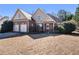 Inviting two-story house with brick accents, a cozy front porch, and a manicured lawn in a sunny setting at 8000 Abington Dr, Locust Grove, GA 30248