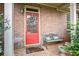 Inviting red front door with brick facade and decorative wreath at 8000 Abington Dr, Locust Grove, GA 30248