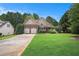 Beautiful two-story home with lush green lawn and brick and siding exterior at 8000 Abington Dr, Locust Grove, GA 30248