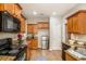 Well-equipped kitchen boasts wood cabinets, granite countertops, and a stainless steel appliance suite at 8000 Abington Dr, Locust Grove, GA 30248