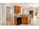 Cozy kitchen area features a breakfast bar, wooden cabinets, and a stainless steel dishwasher at 8000 Abington Dr, Locust Grove, GA 30248