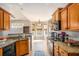 Modern kitchen with wood cabinetry, granite countertops, breakfast nook and natural lighting at 8000 Abington Dr, Locust Grove, GA 30248