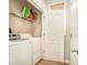 Functional laundry room with white washer and dryer, and shelving for storage at 8000 Abington Dr, Locust Grove, GA 30248