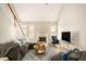 Cozy living room with vaulted ceiling, fireplace, and comfortable seating at 8000 Abington Dr, Locust Grove, GA 30248