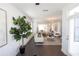 Open living room with hardwood floors, modern lighting and an adjacent dining area and sitting room at 1121 Larkin Dr # 50, Buford, GA 30518