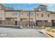 Rear exterior of a townhome with patios, wood fences, and a light post at 116 Via Roma, Woodstock, GA 30188