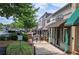 Charming street view of local businesses in a quaint town with tree lined sidewalks at 116 Via Roma, Woodstock, GA 30188