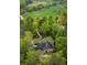 Aerial view of a large home, sports fields, and a long driveway through the trees at 581 Fairfield Nw Rd, Atlanta, GA 30327
