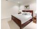Comfortable bedroom features a wooden bed frame, plush carpet, and soft lighting at 581 Fairfield Nw Rd, Atlanta, GA 30327