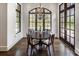 Cozy dining room with hardwood floors, a chandelier, and backyard views at 581 Fairfield Nw Rd, Atlanta, GA 30327