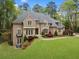 Traditional brick home with well-maintained lawn and detailed landscaping at 581 Fairfield Nw Rd, Atlanta, GA 30327