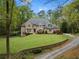 Beautifully landscaped front yard with a stone retaining wall and winding driveway at 581 Fairfield Nw Rd, Atlanta, GA 30327