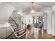 Elegant foyer featuring wood floors, a staircase, and an arched entrance to the living room at 581 Fairfield Nw Rd, Atlanta, GA 30327