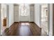 A hallway showcasing dark wood floors, white trim, ample storage, and natural light from a central window at 581 Fairfield Nw Rd, Atlanta, GA 30327