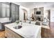 Open kitchen and living area with an island, stone fireplace, and stainless steel appliances at 581 Fairfield Nw Rd, Atlanta, GA 30327