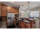 Charming kitchenette with wood cabinetry, stainless steel appliances, and a breakfast bar overlooking the living space at 581 Fairfield Nw Rd, Atlanta, GA 30327