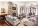 Spacious living room with a stone fireplace, large windows, and comfortable seating at 581 Fairfield Nw Rd, Atlanta, GA 30327