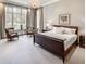 Bright primary bedroom with a large window, chandelier, sitting area and neutral decor at 581 Fairfield Nw Rd, Atlanta, GA 30327