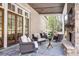 Charming outdoor patio with a stone fireplace and comfortable seating area at 581 Fairfield Nw Rd, Atlanta, GA 30327