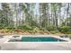 Modern pool featuring a hot tub and a serene backyard setting at 581 Fairfield Nw Rd, Atlanta, GA 30327