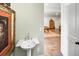 Stylish powder room with a pedestal sink and designer accents near the game room entrance at 581 Fairfield Nw Rd, Atlanta, GA 30327