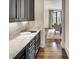Wet bar area with marble countertops, sink, and storage cabinets, near the dining room at 581 Fairfield Nw Rd, Atlanta, GA 30327