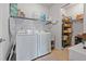 Well-organized laundry room featuring a washer, dryer, shelving, and ample storage space at 5746 Nantucket Row, Hoschton, GA 30548