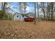 Back of house view with a back deck and a wooded yard, and tire swing at 9635 Loblolly Ln, Roswell, GA 30075