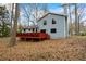 Exterior view of home with a large wooden deck perfect for outdoor entertaining and relaxation amongst the trees at 9635 Loblolly Ln, Roswell, GA 30075