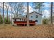 Back of house view with a back deck and wooded backyard at 9635 Loblolly Ln, Roswell, GA 30075