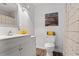 Clean, white bathroom with modern fixtures, a stylish vanity, and a patterned shower curtain at 9635 Loblolly Ln, Roswell, GA 30075