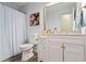 Bathroom featuring a white vanity, framed mirror, and shower/tub with striped curtain at 9635 Loblolly Ln, Roswell, GA 30075