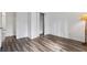 Empty bedroom with hardwood floors and an open closet at 9635 Loblolly Ln, Roswell, GA 30075