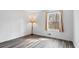 Empty bedroom with a window letting in natural light and showing hardwood floors at 9635 Loblolly Ln, Roswell, GA 30075