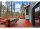 Large wooden deck, featuring a dining area and hot tub, perfect for outdoor relaxation and entertaining at 9635 Loblolly Ln, Roswell, GA 30075