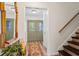 Bright foyer featuring a staircase, wood-look floors, and view of the front door at 9635 Loblolly Ln, Roswell, GA 30075