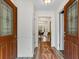 Inviting foyer with wood-look flooring and a decorative runner, leading to a dining area at 9635 Loblolly Ln, Roswell, GA 30075
