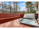 Inviting hot tub on the wooden deck offers a luxurious outdoor relaxation space with a view of the trees at 9635 Loblolly Ln, Roswell, GA 30075