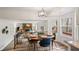 Open concept kitchen and dining area with wood floors, adjacent to a living room at 9635 Loblolly Ln, Roswell, GA 30075