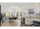 Open kitchen with stainless steel appliances, leading to a cozy living room with a fireplace at 9635 Loblolly Ln, Roswell, GA 30075
