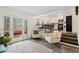 Bright and airy living room with deck access connected to the modern kitchen and dining area at 9635 Loblolly Ln, Roswell, GA 30075