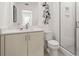 Well-lit bathroom with contemporary fixtures, a toilet, a shower with glass door, and artful decor at 201 New St # 2207-113, Decatur, GA 30030