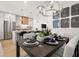 Open-concept dining room with stylish furnishings, art, and kitchen in background at 201 New St # 2207-1, Decatur, GA 30030