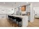 Bright kitchen with stainless steel appliances, a large center island with seating, and hardwood floors at 201 New St # 2207-1, Decatur, GA 30030