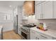 Modern kitchen featuring stainless steel appliances and countertops and a wooden range hood at 201 New St # 2207-1, Decatur, GA 30030