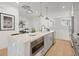 Modern kitchen featuring stainless steel appliances, a center island, and light wood flooring at 201 New St # 2207-1, Decatur, GA 30030